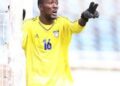 Liberian goalkeeper Tommy Sango in action during a national match, wearing jersey number 16 and pointing from his goalpost.