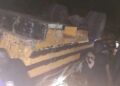 Overturned passenger bus at night after fatal crash near Gbarkor Hill, Bong County, Liberia