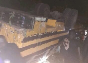 Overturned passenger bus at night after fatal crash near Gbarkor Hill, Bong County, Liberia