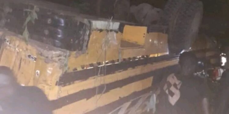 Overturned passenger bus at night after fatal crash near Gbarkor Hill, Bong County, Liberia
