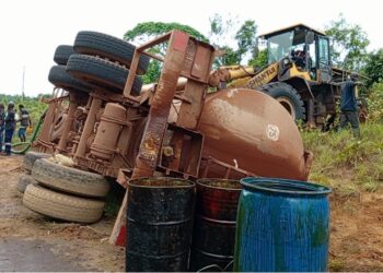 Overturned palm oil tanker with oil drums on the roadside near Harper, Maryland County, Liberia, following a crash on the Harper-Pleebo Highway