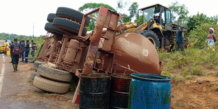 Overturned palm oil tanker with oil drums on the roadside near Harper, Maryland County, Liberia, following a crash on the Harper-Pleebo Highway