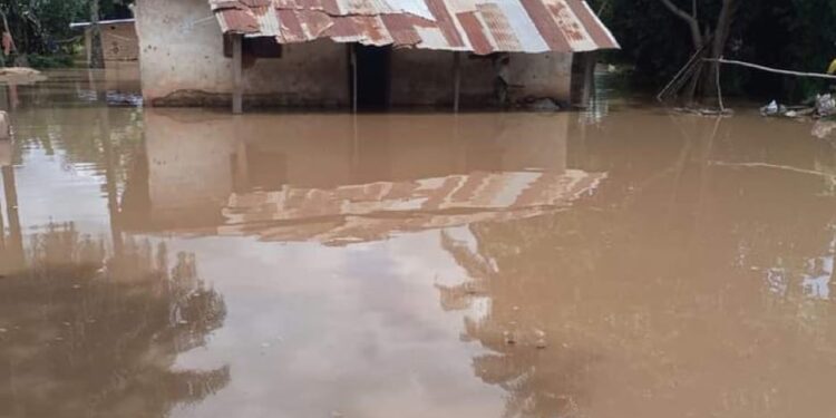 A flooded house in Gbarnga, Bong County, Liberia, surrounded by brown floodwaters with no clear drainage route