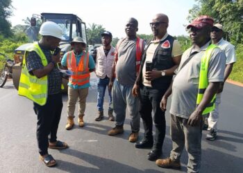 Public Works Minister Roland Giddings and a road crew assess the revived Ganta-to-Zwedru road project site following renewed funding and resumed construction.