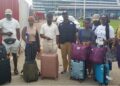 Seven repatriated Liberians and government officials arrive at Roberts International Airport after being rescued from trafficking in Myanmar