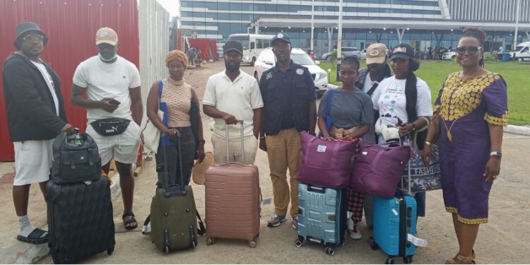 Seven repatriated Liberians and government officials arrive at Roberts International Airport after being rescued from trafficking in Myanmar