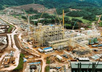 Aerial view of ArcelorMittal Liberia’s newly completed iron ore concentrator in Yekepa, Nimba County, showing heavy machinery, construction structures, and surrounding forested landscape.