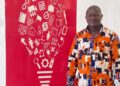 AITB Director General Abraham Billy stands beside a red vocational education-themed backdrop reaffirming the bureau’s commitment to Liberia’s TVET sector.