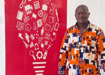 AITB Director General Abraham Billy stands beside a red vocational education-themed backdrop reaffirming the bureau’s commitment to Liberia’s TVET sector.
