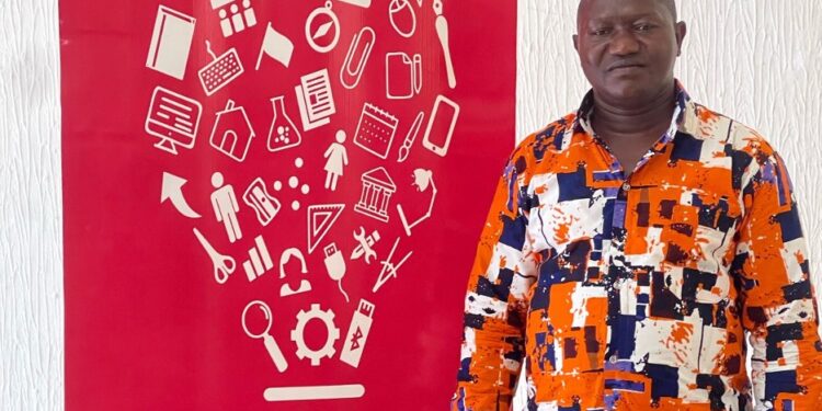 AITB Director General Abraham Billy stands beside a red vocational education-themed backdrop reaffirming the bureau’s commitment to Liberia’s TVET sector.