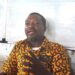 Armstrong Gobac Selekpoh addresses journalists in front of a whiteboard, speaking on behalf of Nimba host communities in defense of the ArcelorMittal Liberia concession deal.