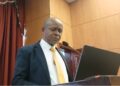 NIR Executive Director Andrews Peter delivering remarks to Liberia’s House of Representatives amid backlash over the biometric national ID program's delays and costs.