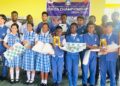 Group of student winners and faculty from Aware International School posing with trophies and chess boards after in-house chess championship in partnership with the Liberia Chess Federation, held in Paynesville in June 2025.