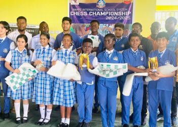Group of student winners and faculty from Aware International School posing with trophies and chess boards after in-house chess championship in partnership with the Liberia Chess Federation, held in Paynesville in June 2025.