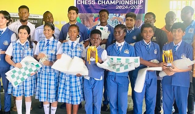 Group of student winners and faculty from Aware International School posing with trophies and chess boards after in-house chess championship in partnership with the Liberia Chess Federation, held in Paynesville in June 2025.
