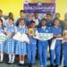 Group of student winners and faculty from Aware International School posing with trophies and chess boards after in-house chess championship in partnership with the Liberia Chess Federation, held in Paynesville in June 2025.
