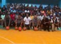 Group photo of participants and coaches at the Sweat Equity two-day basketball camp in Monrovia, held at the YMCA gymnasium with over 100 young athletes in attendance.