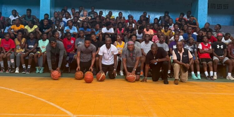 Group photo of participants and coaches at the Sweat Equity two-day basketball camp in Monrovia, held at the YMCA gymnasium with over 100 young athletes in attendance.