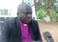 Bishop Kortu Brown addresses the media, criticizing the Liberian government’s timing of opposition lawmakers’ arrests during a national celebration