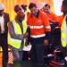 President Joseph Nyuma Boakai shakes hands with ArcelorMittal Executive Chairman Lakshmi Mittal during the inauguration of the $1.8 billion iron ore concentrator in Tokadeh, Nimba County, surrounded by executives and engineers in safety gear