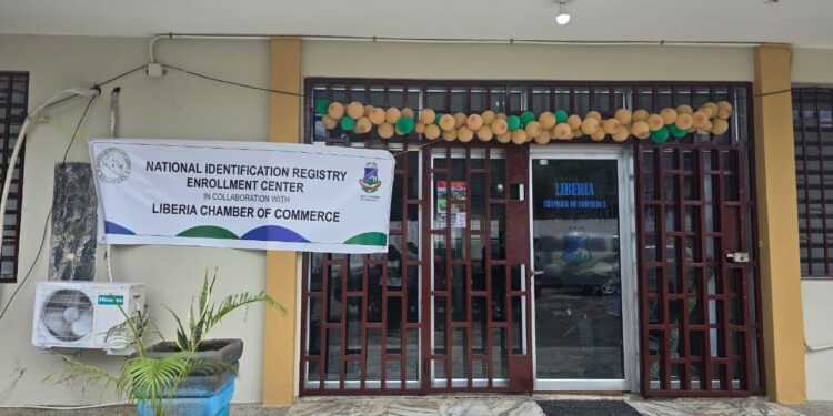 Front view of the Liberia Chamber of Commerce building in Monrovia with a banner announcing the launch of the National Identification Registry Enrollment Center.