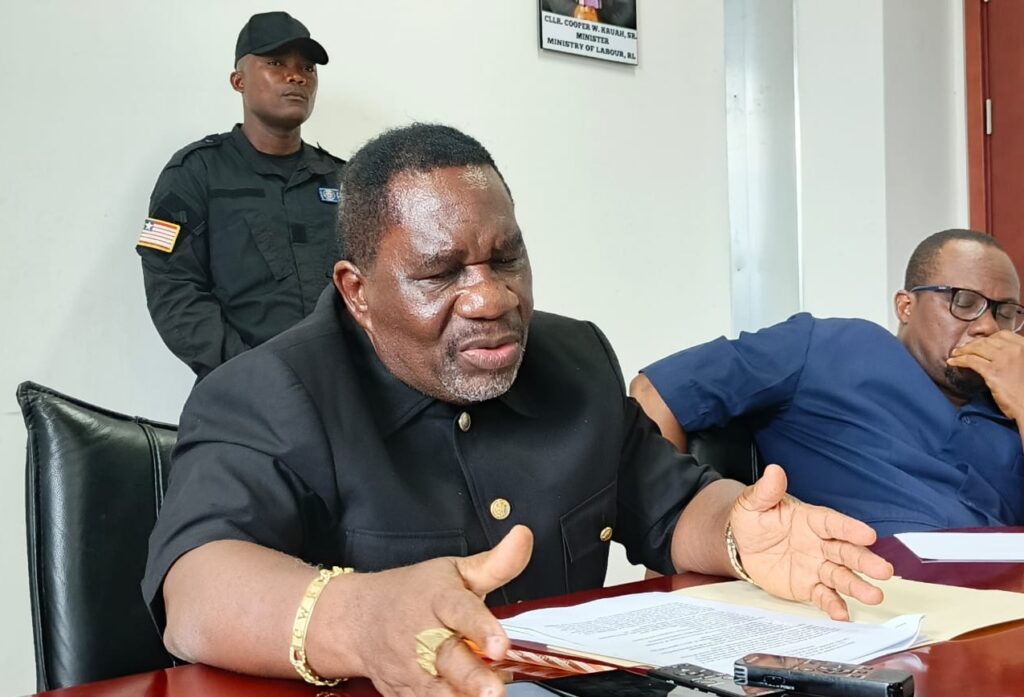 Liberia’s Labor Minister Cooper W. Kruah Sr. speaking during a press conference as he faces scrutiny over unauthorized work permit waivers to Chinese workers.