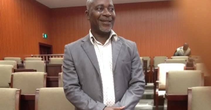 Deputy Chief Clerk Commicks Chea stands inside the chamber of Liberia’s House of Representatives, days before his untimely passing.