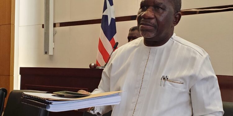 Labor Minister Cllr. Cooper W. Kruah presents a detailed report to the Liberian Senate defending over 10,000 work permits issued in 2024.