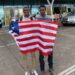 Douglas Sackor and Shaun Toteh hold a Liberian flag at the airport before departing for European football trials in Accra, Ghana.