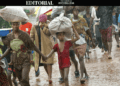 Liberian war victims walk in the rain during conflict displacement—symbolizing the unfulfilled promise of justice decades after the civil wars ended.