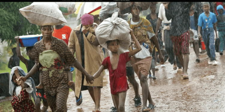 Liberian war victims walk in the rain during conflict displacement—symbolizing the unfulfilled promise of justice decades after the civil wars ended.