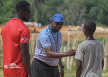 FIFA Talent Coach Ammy Ninje interacts with young footballers in Liberia during a nationwide scouting tour under the FIFA Talent Development Scheme.