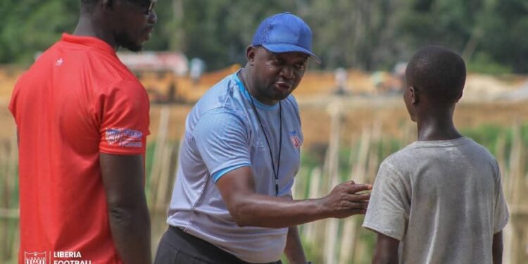 FIFA Talent Coach Ammy Ninje interacts with young footballers in Liberia during a nationwide scouting tour under the FIFA Talent Development Scheme.
