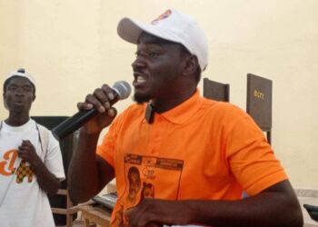 Kongoi Gborkorquellie speaks passionately during his campaign launch at Bong County Technical College, wearing an SPC shirt and cap as he outlines plans for a campus clinic.
