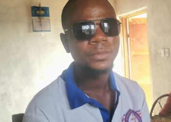 George Harmon, a Liberian worker in Kakata, wears protective sunglasses after suffering cement burns allegedly caused by his Syrian supervisor at a World Bank-funded construction site