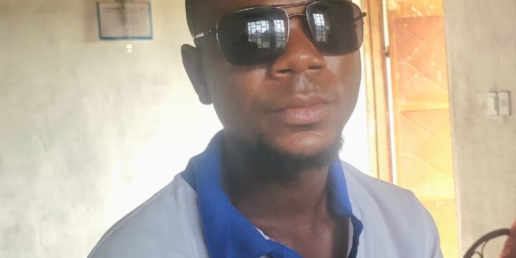 George Harmon, a Liberian worker in Kakata, wears protective sunglasses after suffering cement burns allegedly caused by his Syrian supervisor at a World Bank-funded construction site