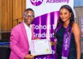 Gonet Academy Founder and CEO Mohamed Kerkula presents a professional certificate in Monitoring and Evaluation to a female graduate during Cohort 11 graduation ceremony