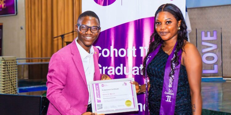 Gonet Academy Founder and CEO Mohamed Kerkula presents a professional certificate in Monitoring and Evaluation to a female graduate during Cohort 11 graduation ceremony