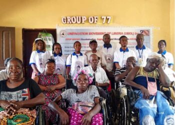 Group of 77 members, including persons with disabilities, gather for a donation ceremony with officials of the Unification Movement of Liberia at their Monrovia headquarters.
