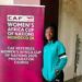 Liberian referee Hannah Moses stands beside a CAF Women’s Africa Cup of Nations preparation course banner during elite training in Cairo, Egypt.