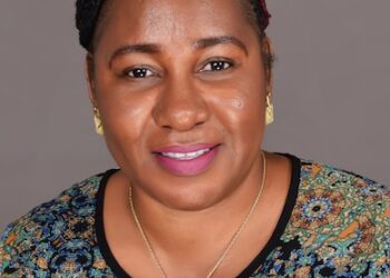 Harriette Mondaye, newly appointed Country Director for Americares Liberia, smiling in a professional portrait wearing a patterned top and gold jewelry