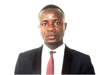 ortrait of Isaac T.Z. Montgomery, former Secretary-General of the Liberia Football Association, dressed in a dark suit and red tie, responding to an ongoing LACC corruption probe.
