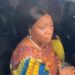 Former Vice President Jewel Howard-Taylor sits inside a vehicle, speaking to reporters after visiting jailed lawmakers at the Monrovia Central Prison, wearing a colorful traditional outfit and pearl necklace.