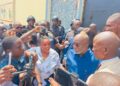 Former Speaker J. Fonati Koffa emerges from Monrovia Central Prison surrounded by supporters and security after posting a US$440,000 bond in the Capitol fire case