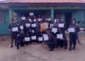 Graduating LDEA officers display training certificates in front of the Grand Gedeh County Detachment after completing specialized anti-drug training.