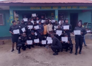 Graduating LDEA officers display training certificates in front of the Grand Gedeh County Detachment after completing specialized anti-drug training.