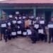 Graduating LDEA officers display training certificates in front of the Grand Gedeh County Detachment after completing specialized anti-drug training.