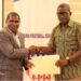 FA Deputy Secretary-General Muhammed Sheriff and NHSS Executive Director Dionysius Sebwe shake hands during the signing of a two-year grassroots football development partnership.