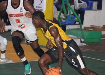 LPRC Oilers player drives past a Mighty Barrolle defender during their First Division League clash at SKD Gymnasium