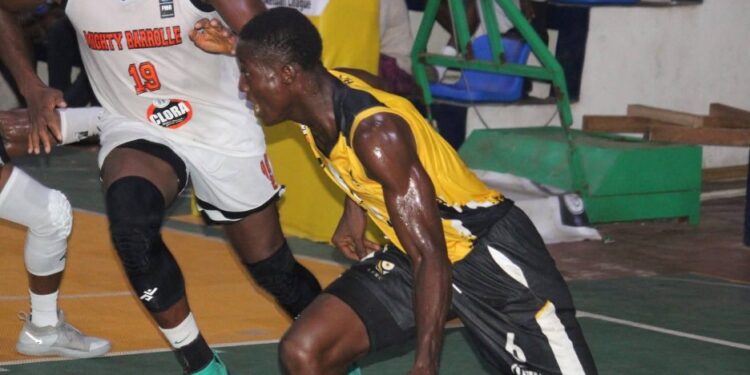 LPRC Oilers player drives past a Mighty Barrolle defender during their First Division League clash at SKD Gymnasium